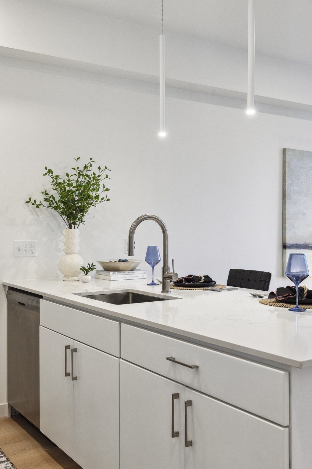 a kitchen with white cabinets and a sink and a white counter top