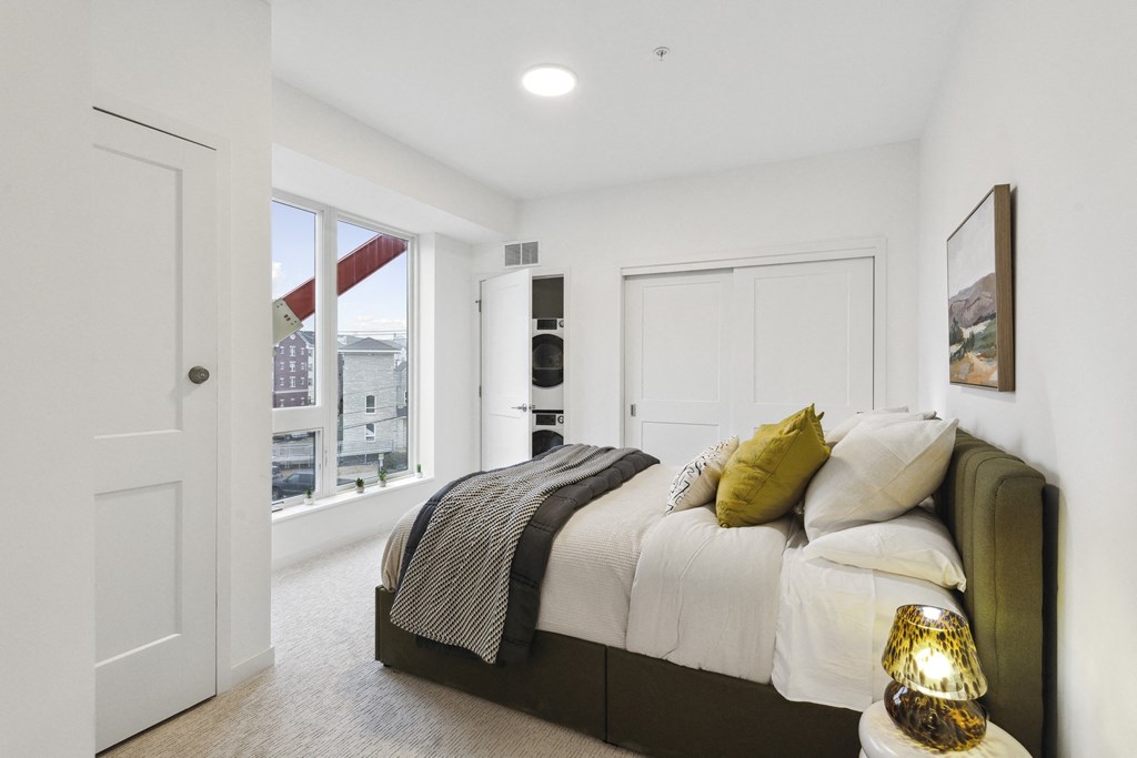 a bedroom with a large bed and a window