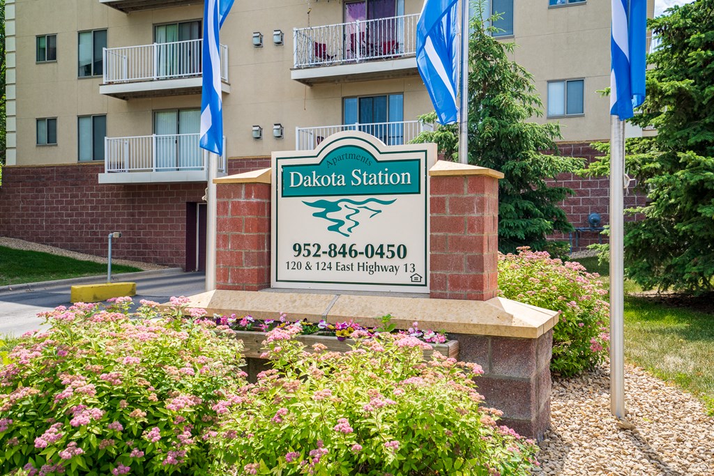 an image of the station sign in front of an apartment building