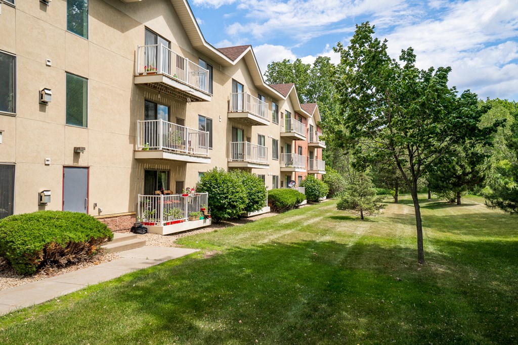 our apartments are located in a quiet neighborhood with green grass and trees