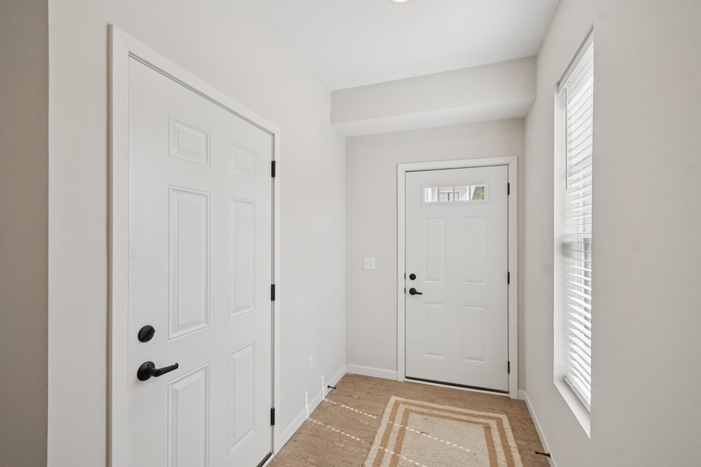 Front entry hallway with access to the garage  at Ironwood Townhomes in Medina, Minnesota.