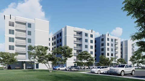 A modern apartment complex with cars parked in front.