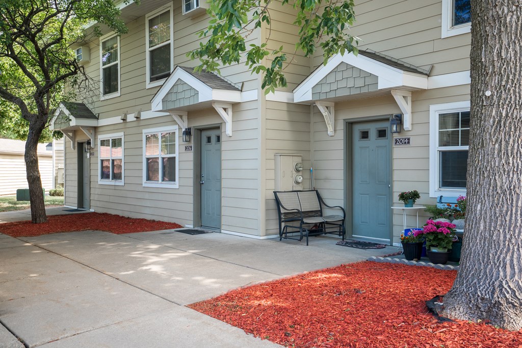 a front porch with a bench in front of a house