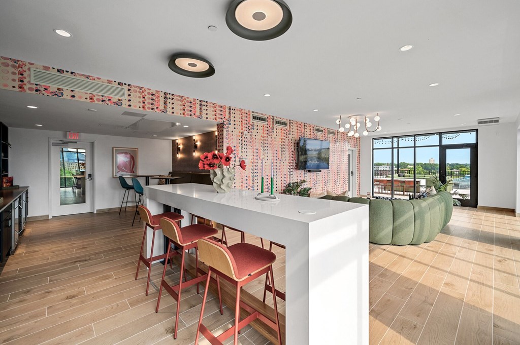 community room kitchen with a long white counter and chairs