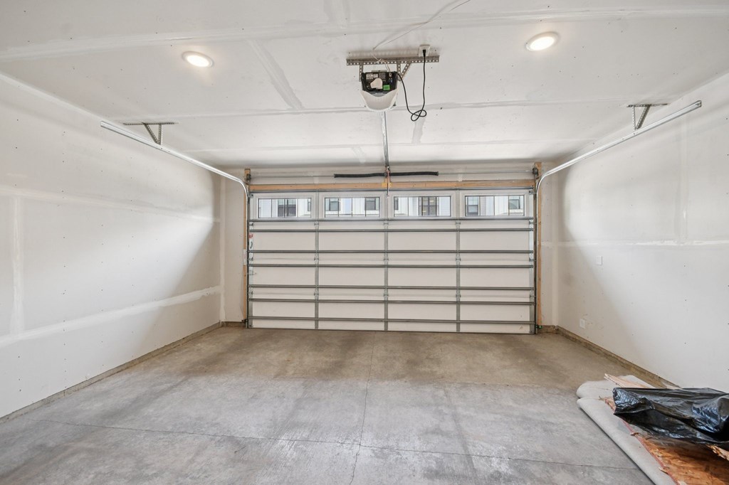 A garage with a closed shutter door and a security camera mounted on the ceiling  at Ironwood Townhomes in Medina, Minnesota.