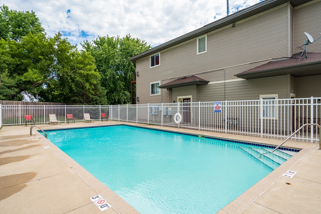 the swimming pool at our apartments with a fence around it
