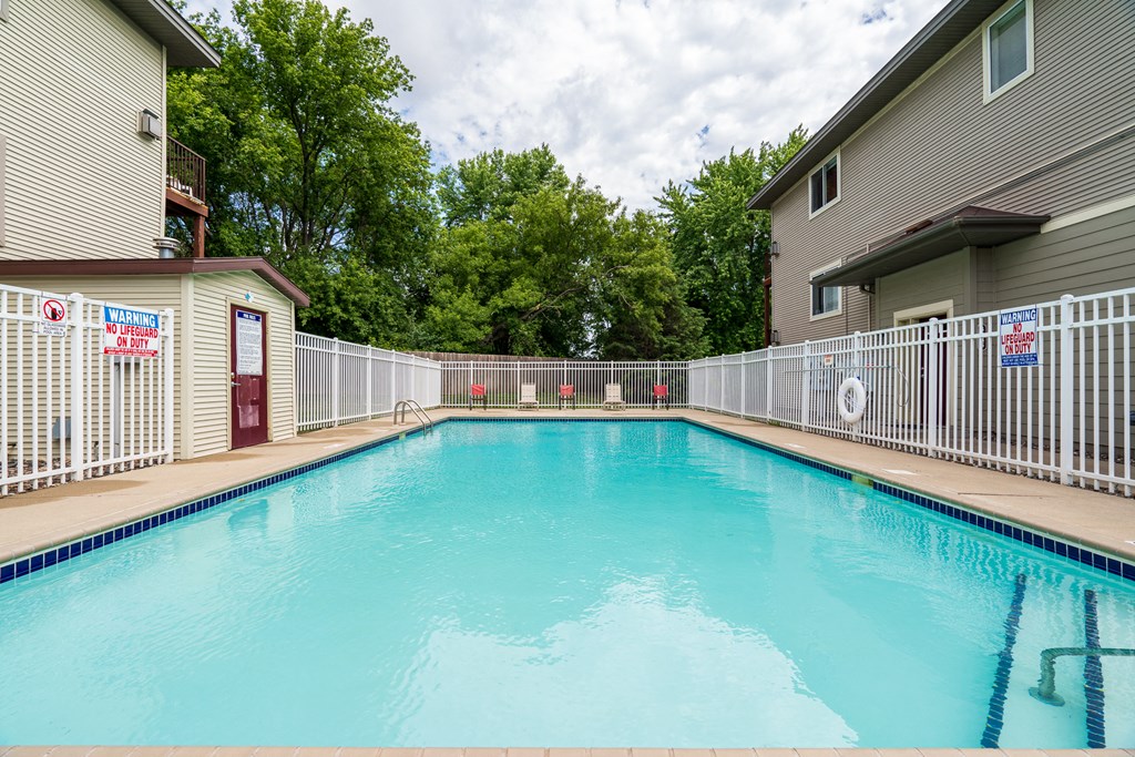 the swimming pool at our apartments with a fence around it