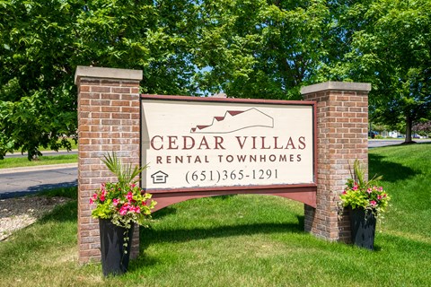 a sign villas rental condos in front of trees