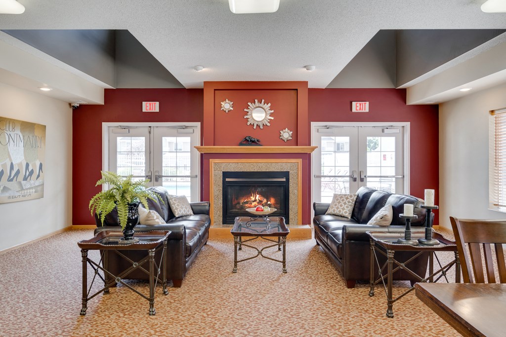 a living room with red walls and a fireplace