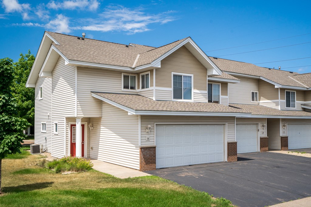 a white house with a garage and a driveway