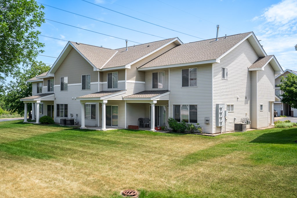 a white house with a yard in front of it