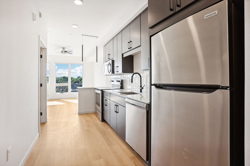 a kitchen with stainless steel appliances and white cabinets