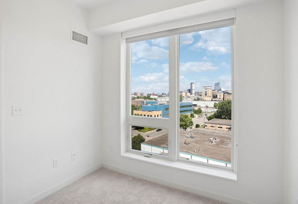 an ornate white plaster wall with a window