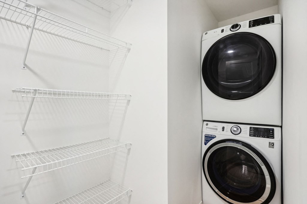 a washer and dryer in a laundry room next to a white closet