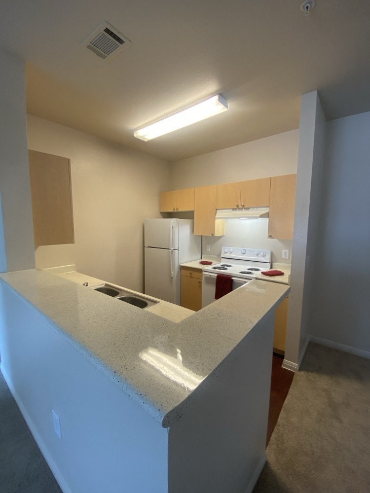 an empty kitchen with an island in the middle