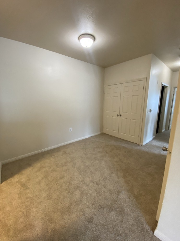 a room with a carpeted floor and a white door