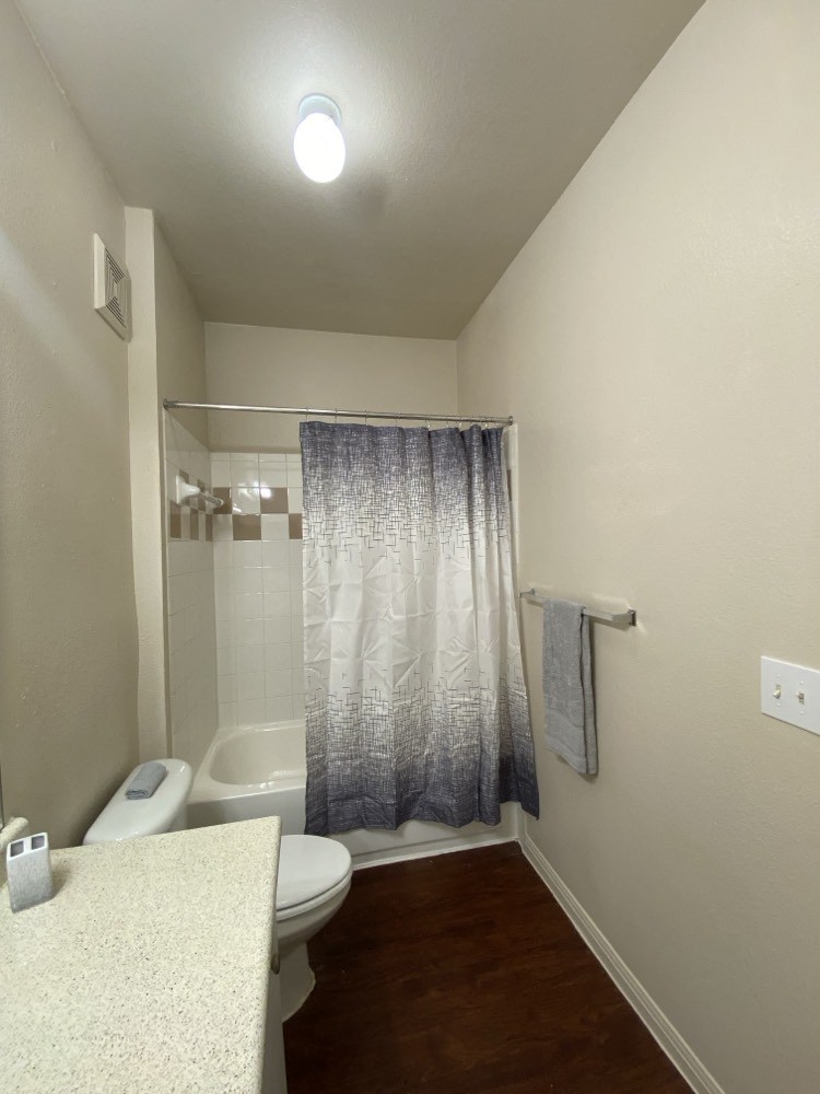 a small bathroom with a shower toilet and sink