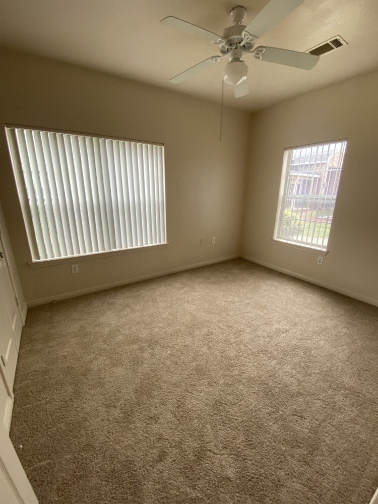 a bedroom with a bed and a ceiling fan