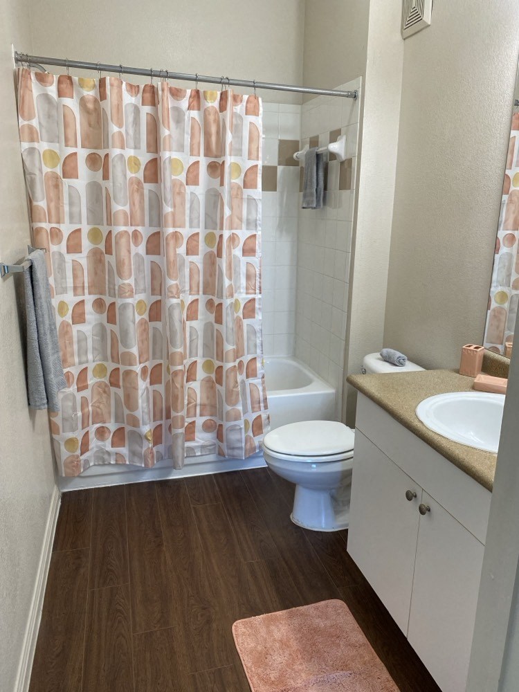 a bathroom with a toilet and a shower curtain