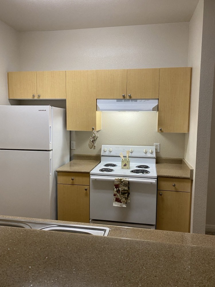 a kitchen with a stove and a refrigerator