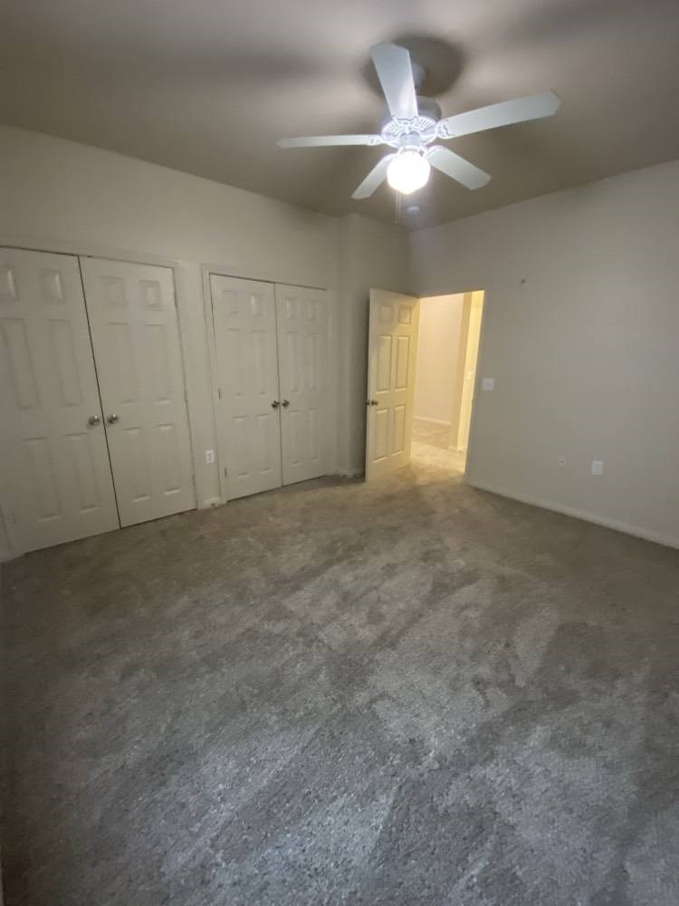 an empty room with a ceiling fan in it
