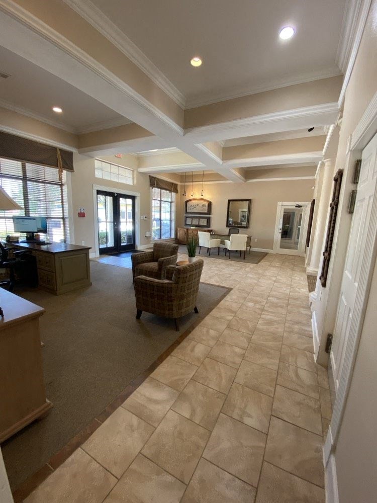 a large living room with a couch and a chair