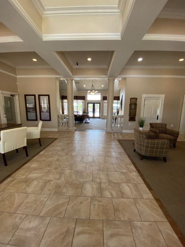 a large hallway with chairs and tables and a couch