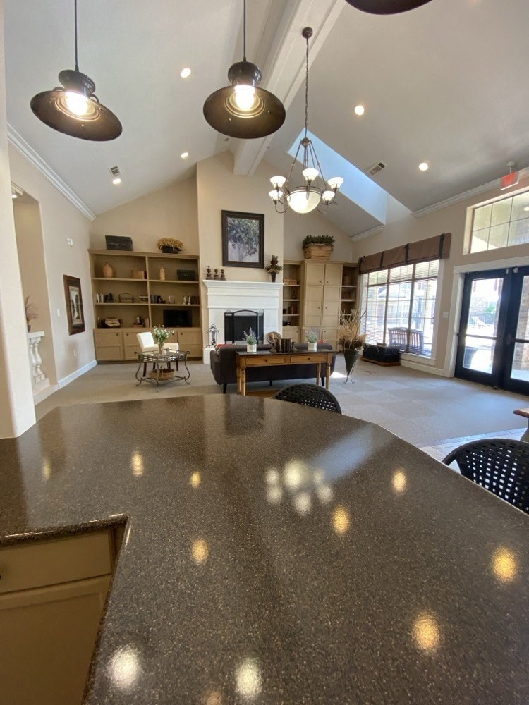 a large living room with a table and a fireplace