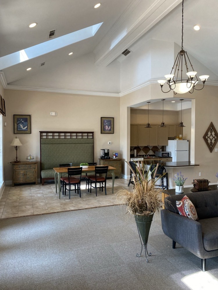 a living room and dining room with a table and chairs