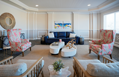 A living room with a sofa, two chairs, and a coffee table.
