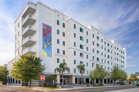 a large white building with a mural on the side of it