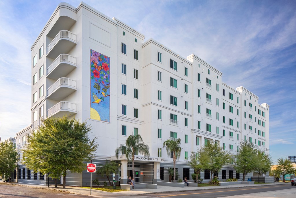 a large white building with a mural on the side of it