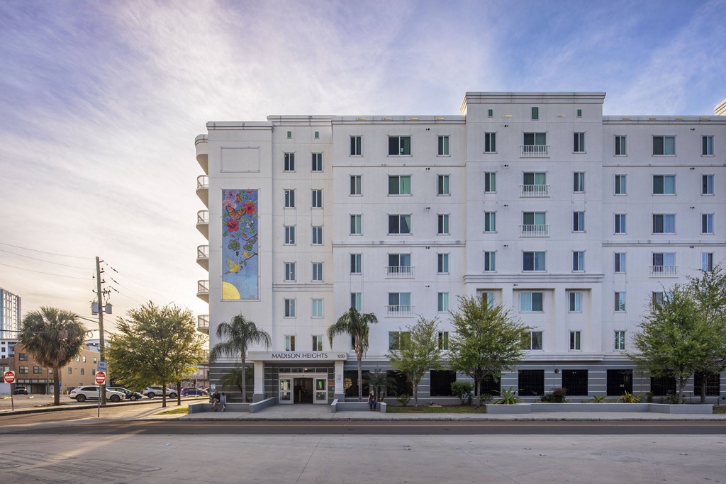 a large white building with a mural on the side of it