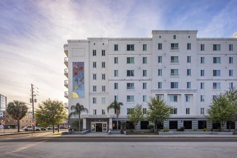 A large white building with a mural on the side.