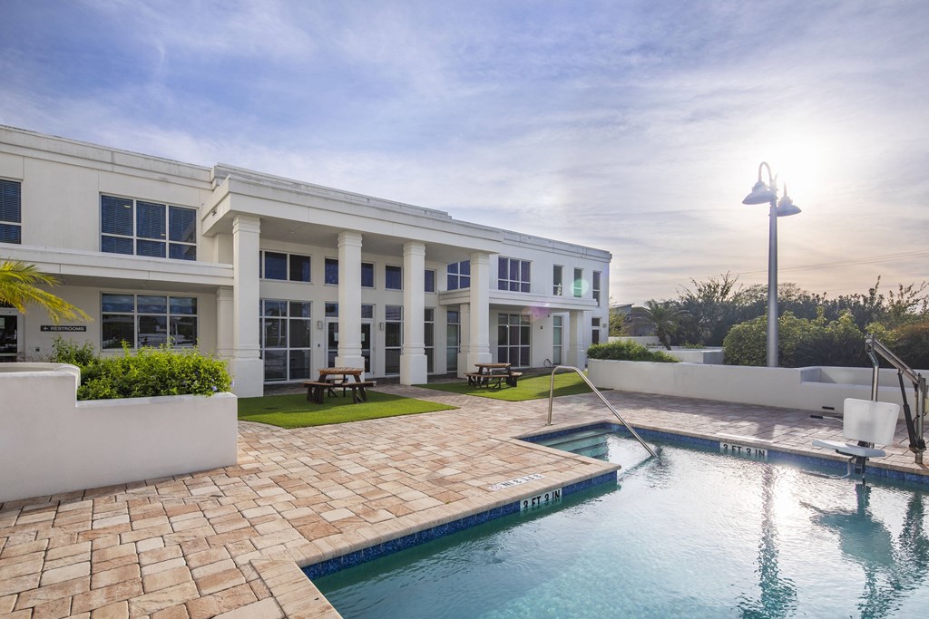 a swimming pool with a building in the background