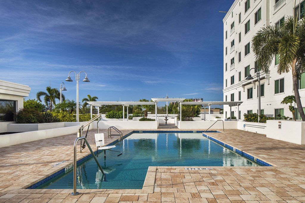 a swimming pool at a hotel in front of a building
