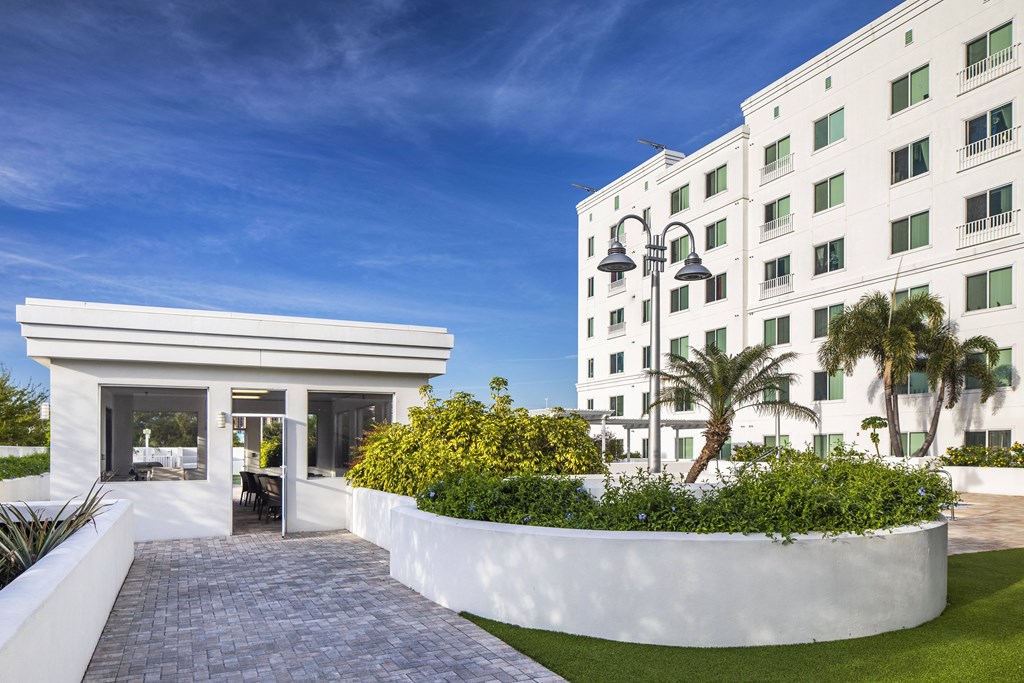 a large white hotel building with a pathway in front of it