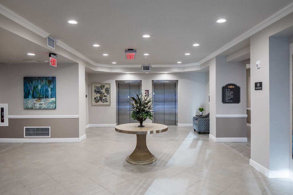 A large, well-lit lobby with a round table in the center.