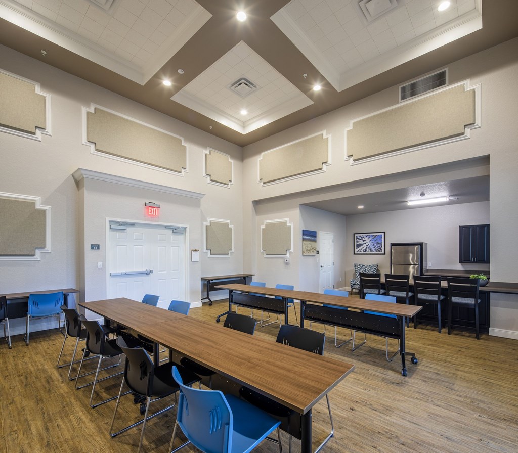 A conference room with a long table and chairs.