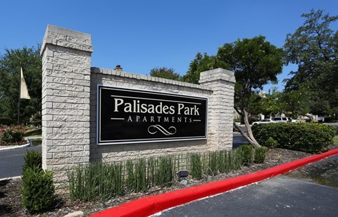 monument sign for palisades park apartments in front of a road