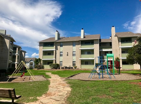 an image of a playground in front of an Palisades Park Apartments