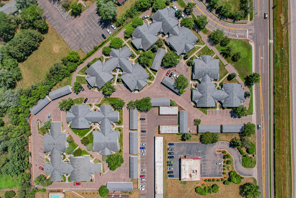 an aerial view of a suburban neighbourhood with a parking lot