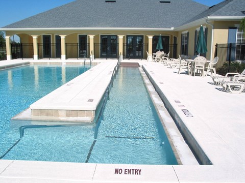 a swimming pool in front of a house with a no entry sign