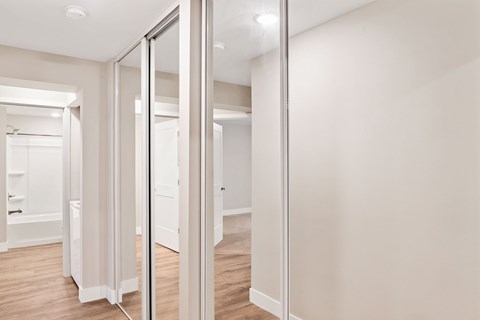 A white room with a mirror on the wall.