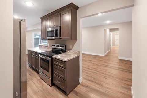 A kitchen with brown cabinets at Santa Vera Apartments in Chanhassen..