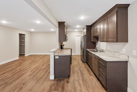 A kitchen with brown cabinets and a white refrigerator.