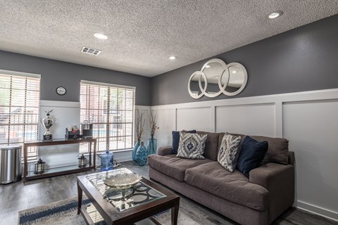 A living room with a brown couch and a coffee table.