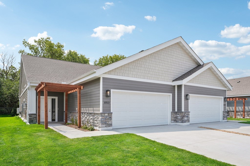 Country Club Villas Twin Home with a white garage door and a driveway