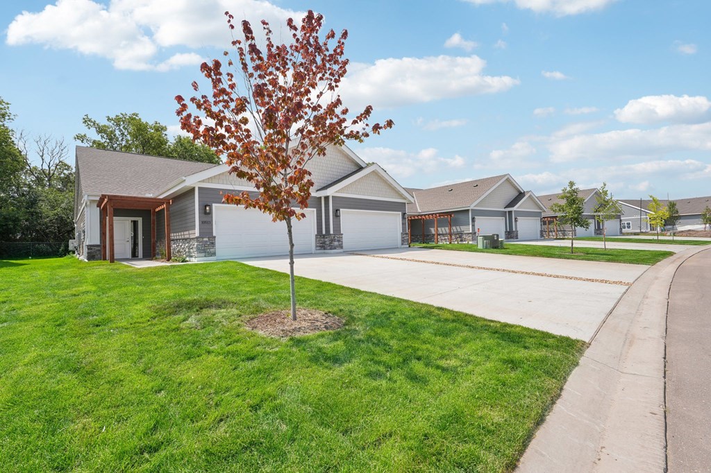 Country Club Villas a house with a driveway and a tree in front of it