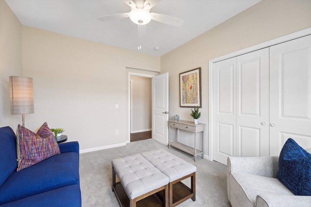 multi use room with white walls and a ceiling fan